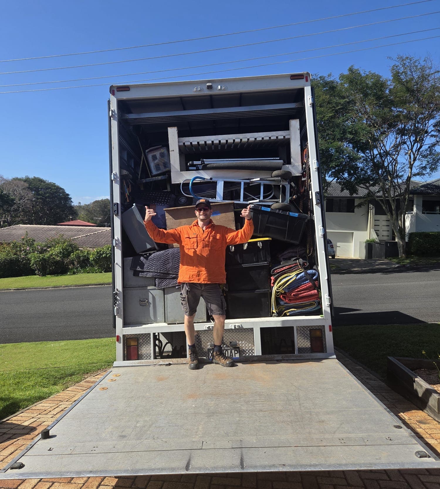 Ariel on the tail-lift in front of a fully loaded Ready To Move truck