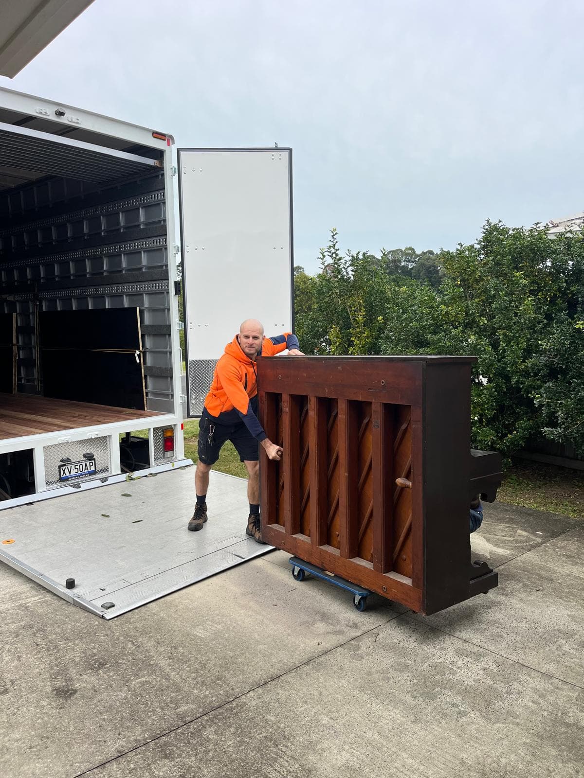 Piano dolly with a piano strapped, ready to load on a Ready To Move truck